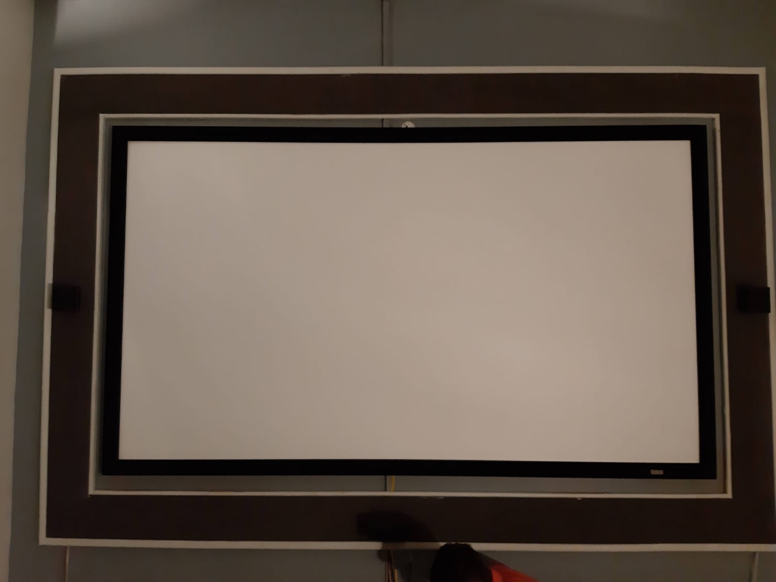 Installed projection screen with architectural frame